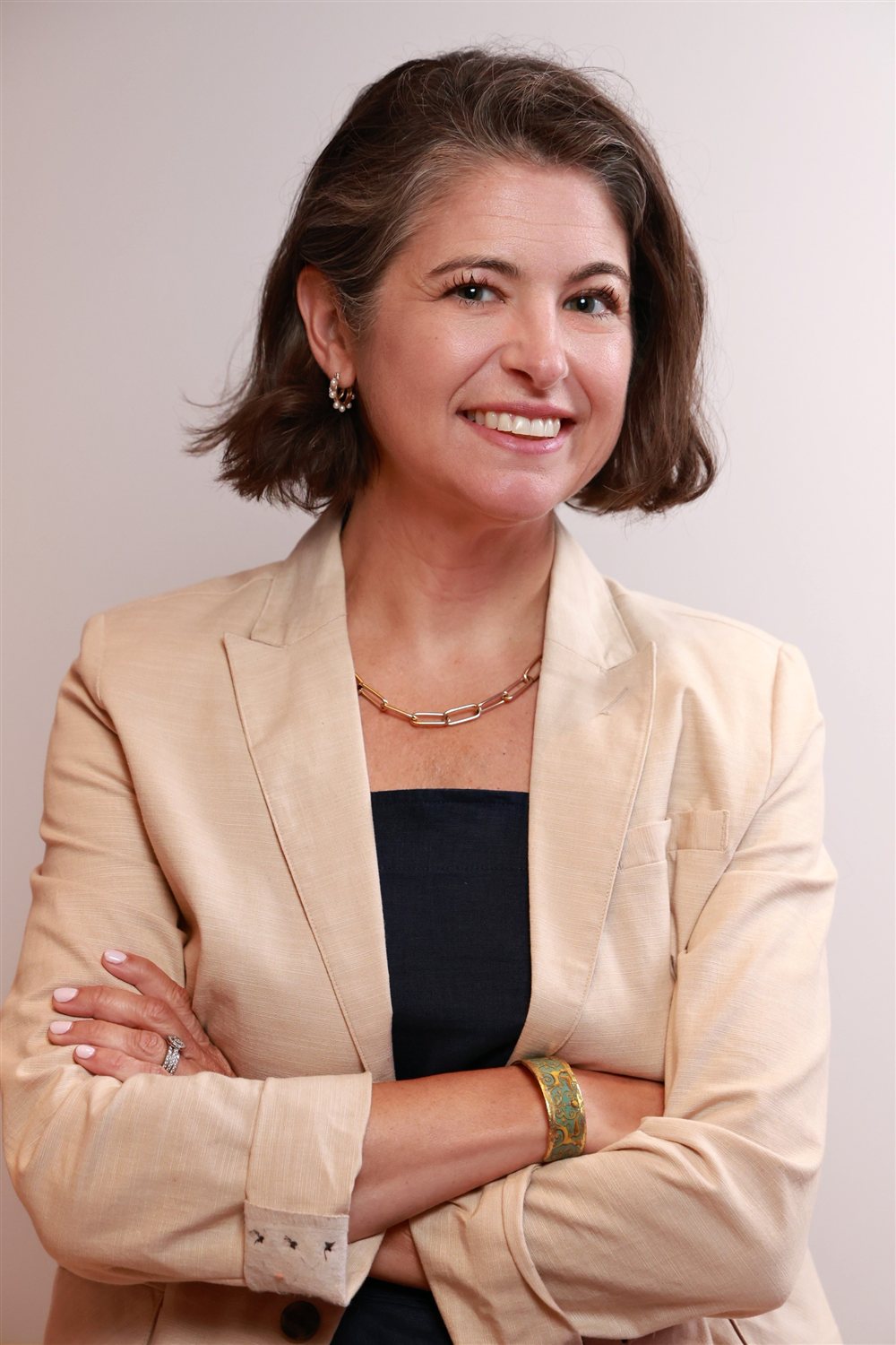 Julie Peller, founder of Peller Strategies, smiling with arms crossed